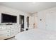 Bright bedroom features a TV on a dresser, neutral walls, and a doorway to a walk-in closet at 1206 Keydet Dr, Charlotte, NC 28216