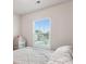 Bright bedroom showcasing a large window with a neighborhood view, and neutral-toned walls at 1206 Keydet Dr, Charlotte, NC 28216