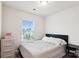Bedroom with a modern black headboard, neutral bedding, and a window view at 1206 Keydet Dr, Charlotte, NC 28216