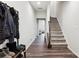 Inviting entryway with hardwood floors, coat rack, and staircase leading to the upper level at 1206 Keydet Dr, Charlotte, NC 28216