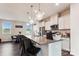 Bright kitchen features granite countertops, a stainless steel fridge, and three pendant lights overhanging the island at 1206 Keydet Dr, Charlotte, NC 28216