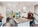 Open concept kitchen with a granite countertop island, stainless steel appliances, and an adjacent living room at 1206 Keydet Dr, Charlotte, NC 28216