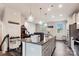 This updated kitchen is equipped with granite countertops, stainless steel appliances, and modern pendant lighting at 1206 Keydet Dr, Charlotte, NC 28216