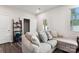 Comfortable living room featuring a large sofa, a window, and a doorway leading to another room at 1206 Keydet Dr, Charlotte, NC 28216