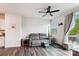 Bright living room with hardwood floors, a modern ceiling fan, and access to a private balcony at 1206 Keydet Dr, Charlotte, NC 28216
