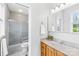 A bright bathroom equipped with a tiled shower, vanity, and ample lighting at 1305 Glenview Ln, Rock Hill, SC 29730