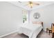 Bright bedroom with a ceiling fan, a comfortable bed, and a large window bringing in natural light at 1305 Glenview Ln, Rock Hill, SC 29730