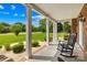 Relaxing front porch with rocking chair, brick accents, and landscaped yard overlooking a lush green lawn at 1305 Glenview Ln, Rock Hill, SC 29730