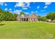 Beautiful brick home featuring a well-manicured lawn, classic architecture, and inviting front porch at 1305 Glenview Ln, Rock Hill, SC 29730