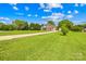 Charming brick home with lush green lawn, mature trees, and a long driveway at 1305 Glenview Ln, Rock Hill, SC 29730