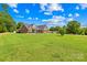 Lovely brick home with well-maintained landscaping, mature trees, and a long driveway at 1305 Glenview Ln, Rock Hill, SC 29730