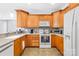 A view of the kitchen area with wood cabinets and grey countertops at 1305 Glenview Ln, Rock Hill, SC 29730