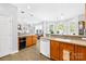 Open-concept kitchen area with an island, built-in appliances, and tile flooring at 1305 Glenview Ln, Rock Hill, SC 29730