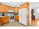 Well-lit kitchen features wooden cabinets, white appliances, and tile floors at 1305 Glenview Ln, Rock Hill, SC 29730
