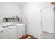 Functional laundry room equipped with a washer, dryer, and convenient storage shelving at 1305 Glenview Ln, Rock Hill, SC 29730