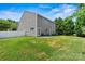 Large backyard with a well-kept lawn, white fencing, and ample space for recreation and gardening at 142 Wellshire St, Mooresville, NC 28115