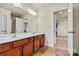 This bathroom boasts a double sink vanity, large mirrors, and an open doorway, offering a bright and inviting space at 142 Wellshire St, Mooresville, NC 28115