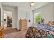 A comfortable bedroom with a colorful patterned bedspread, neutral walls, and wood dresser at 142 Wellshire St, Mooresville, NC 28115