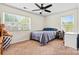 Bedroom featuring natural light, a fan, and a comfortable bed and bedside table at 142 Wellshire St, Mooresville, NC 28115