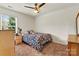 A cozy bedroom with a floral comforter on the bed, complemented by neutral walls, and soft natural light at 142 Wellshire St, Mooresville, NC 28115