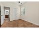 Bright bedroom with a view to the ensuite bathroom, neutral carpeting, ceiling fan, and closet at 142 Wellshire St, Mooresville, NC 28115