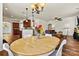 Open floor plan dining area with hardwood floors, a chandelier, and open to the kitchen and living room at 142 Wellshire St, Mooresville, NC 28115