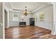 Formal dining room features hardwood floors, wainscotting, lots of natural light, and a chandelier at 142 Wellshire St, Mooresville, NC 28115