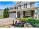 Inviting front entrance with a brick pathway, well-maintained landscaping, and a charming porch at 142 Wellshire St, Mooresville, NC 28115