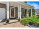 Cozy front porch featuring stone pillars, a decorative door, and manicured landscaping for curb appeal at 142 Wellshire St, Mooresville, NC 28115
