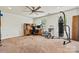 A carpeted bonus room with workout equipment, desk with computer, and good lighting at 142 Wellshire St, Mooresville, NC 28115
