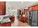 Modern kitchen showcasing dark wood cabinetry, stainless steel appliances, and an adjacent breakfast area at 142 Wellshire St, Mooresville, NC 28115