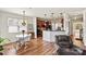 Open kitchen area with hardwood floors, a breakfast nook, dark wood cabinets, and modern appliances at 142 Wellshire St, Mooresville, NC 28115