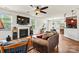 Bright living room features hardwood floors, a fireplace, a mounted tv, and lots of natural light at 142 Wellshire St, Mooresville, NC 28115
