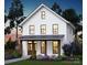 Inviting two-story modern farmhouse boasting a covered front porch and well-manicured landscaping at 1427 Rankin Ave, Gastonia, NC 28052