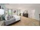 Spacious primary bedroom featuring plush carpeting and a private en suite bathroom with a shower at 143 Apple Orchard Ct, Statesville, NC 28677