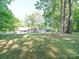 Spacious backyard with lush greenery and a storage shed at 145 Woodview Dr, Statesville, NC 28625