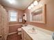 Bright bathroom featuring a white vanity and framed mirror at 145 Woodview Dr, Statesville, NC 28625