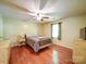 Bedroom with hardwood floors, ceiling fan and bedside tables at 145 Woodview Dr, Statesville, NC 28625