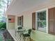 A cozy front porch with decorative tile, seating for two, and an American flag hanging on the wall at 145 Woodview Dr, Statesville, NC 28625