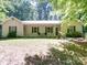 Charming ranch style home with neutral siding, shutters, and a front porch area with seating at 145 Woodview Dr, Statesville, NC 28625