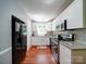 Modern kitchen featuring white cabinets, stainless steel appliances, granite counters, and wood flooring at 145 Woodview Dr, Statesville, NC 28625