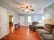 Spacious living room with hardwood floors, light blue walls, a ceiling fan, and a comfortable seating area at 145 Woodview Dr, Statesville, NC 28625