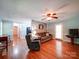 Bright living room featuring hardwood floors, neutral walls, a ceiling fan and comfortable seating at 145 Woodview Dr, Statesville, NC 28625