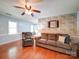 Light filled living room featuring hardwood floors, neutral walls, ceiling fan and comfortable seating at 145 Woodview Dr, Statesville, NC 28625
