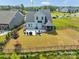 Aerial view of fenced backyard with patio, grill area, and well-maintained lawn at 1497 Striped Bass Ln, Clover, SC 29710