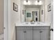 Stylish bathroom with dual sinks, a large mirror, and modern fixtures at 1497 Striped Bass Ln, Clover, SC 29710