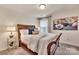 Cozy bedroom with wood-frame bed, plush bedding, soft lighting, and relaxing decor at 1497 Striped Bass Ln, Clover, SC 29710