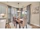 Cozy dining area with natural light, elegant curtains, and a rustic wooden table at 1497 Striped Bass Ln, Clover, SC 29710