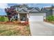 Charming home featuring a two-car garage, covered porch, and beautifully landscaped front yard at 1497 Striped Bass Ln, Clover, SC 29710