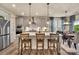 Modern kitchen with gray cabinets, quartz countertops, island, and adjacent dining area at 1497 Striped Bass Ln, Clover, SC 29710